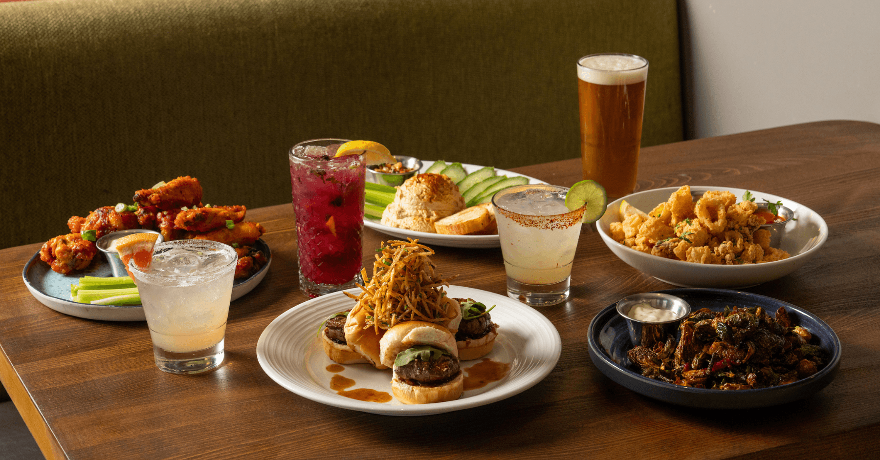 Tenderloin Sliders, Signature Wings, crispy glazed Brussels sprouts, calamari and hummus with beer and cocktails.