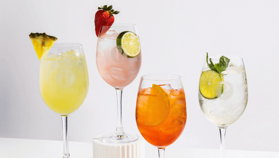 Four summer spritz cocktails—Aperol, Hugo, Tropical, and Berry—lined up on the bar, available June 1 to September 7.