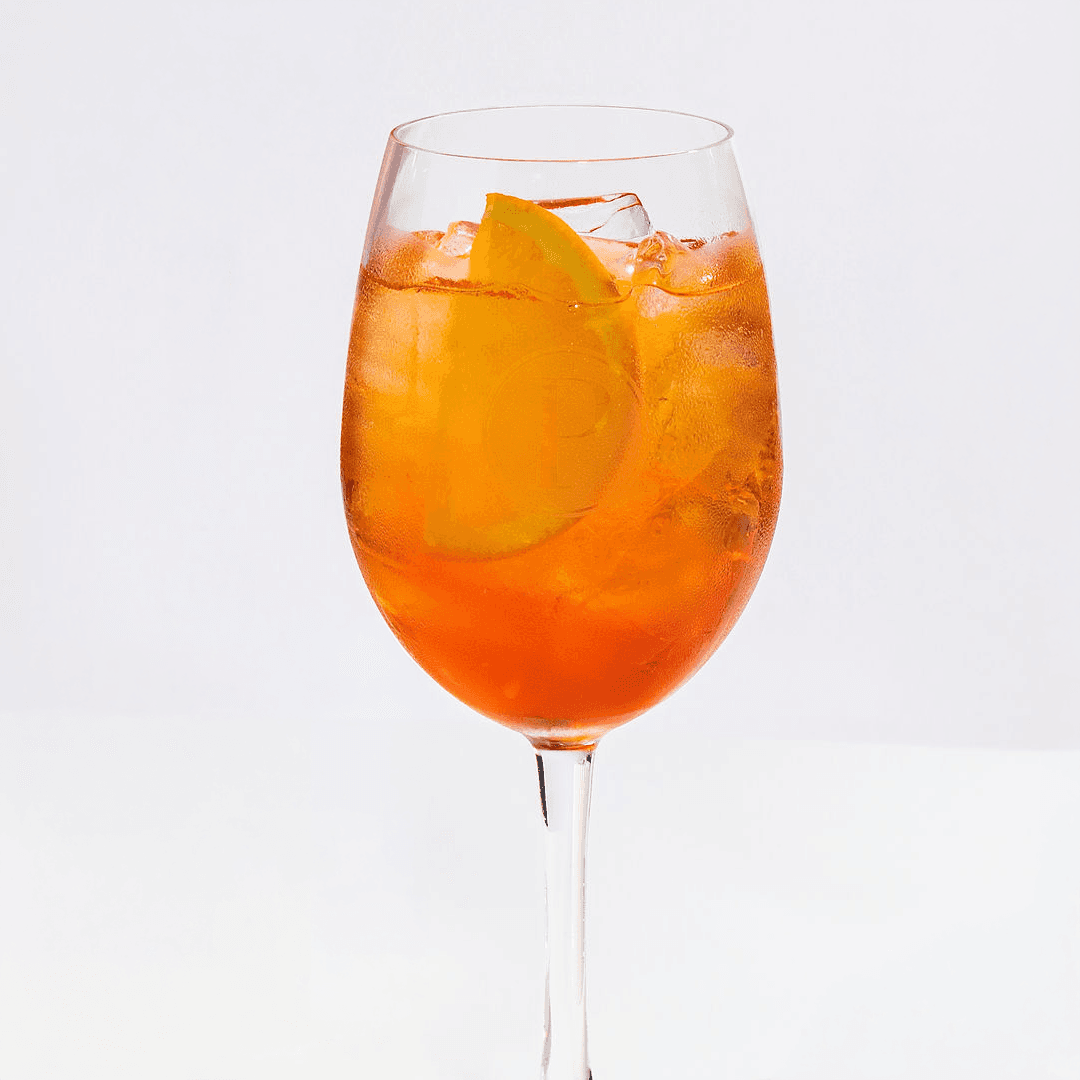 Aperol spritz cocktail in a Pinstripes logo glass garnished with orange on the summer spritz menu