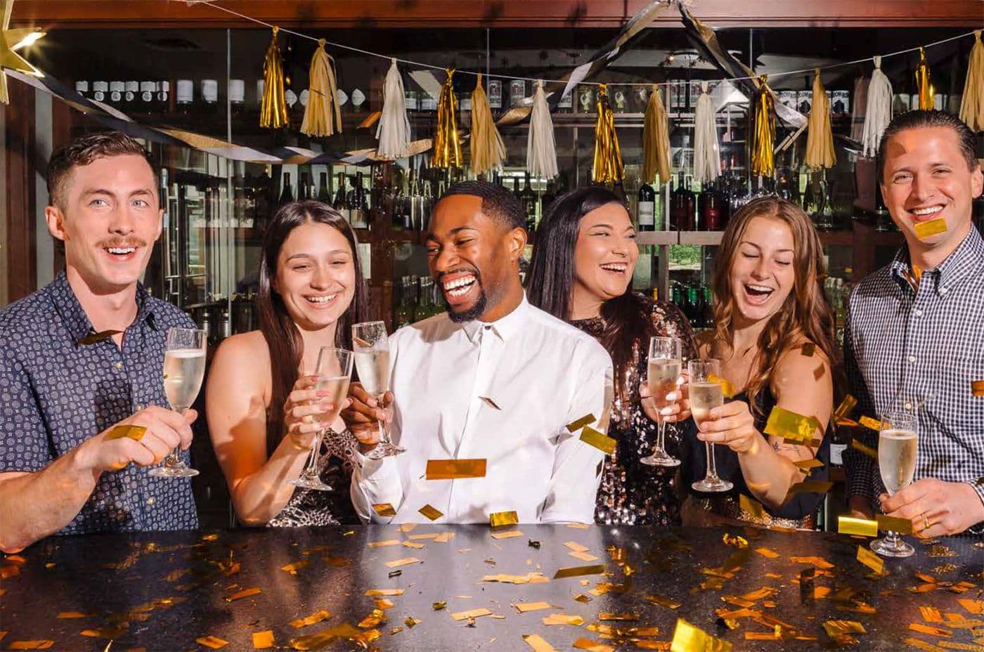 Coworkers cheersing and having a good time at an event.